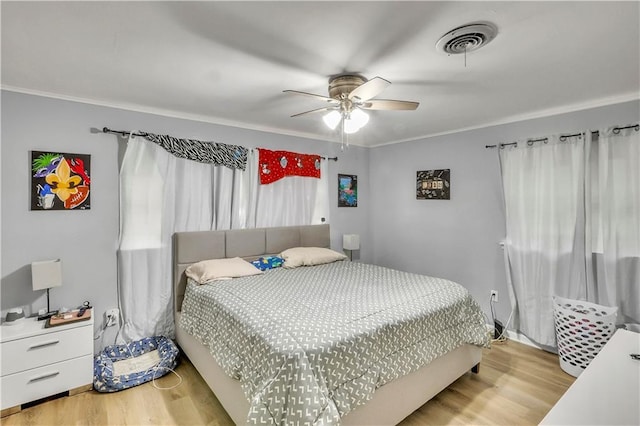 620 Maryland Ave, Metairie, LA 70003 - bedroom featuring ceiling fan, visible vents, wood finished floors, and ornamental molding