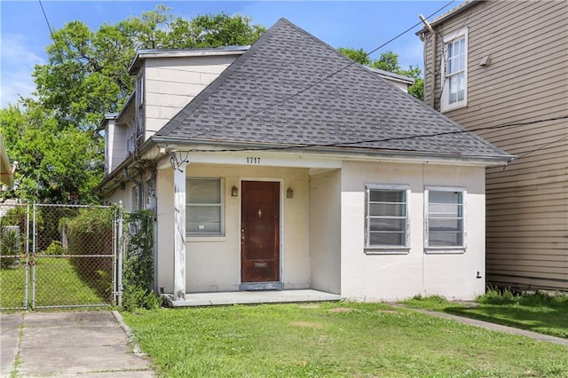 1717 Foucher St, New Orleans, LA 70115 - bungalow with fence, a shingled roof, a gate, and a front lawn