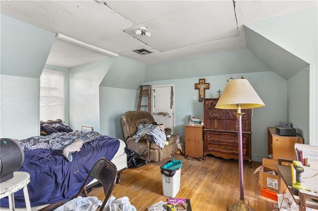 1717 Foucher St, New Orleans, LA 70115 - bedroom featuring wood-type flooring, lofted ceiling, and visible vents