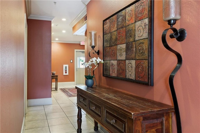 hall featuring light tile patterned floors, baseboards, ornamental molding, and recessed lighting