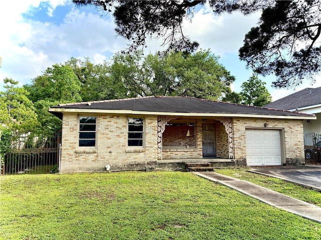 single story home with covered porch, a front yard, brick siding, an attached garage, and driveway