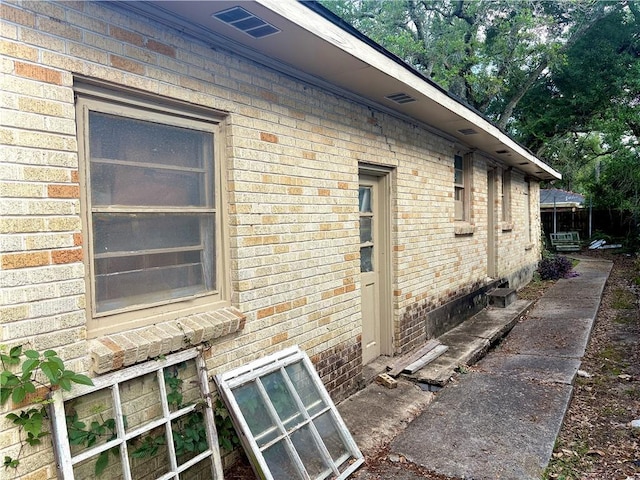 view of side of home featuring brick siding