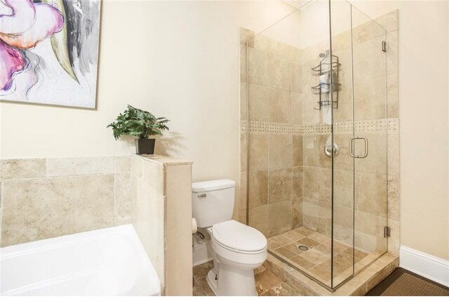2608 Republic St, New Orleans, LA 70119 - full bath with a stall shower, toilet, a garden tub, and baseboards