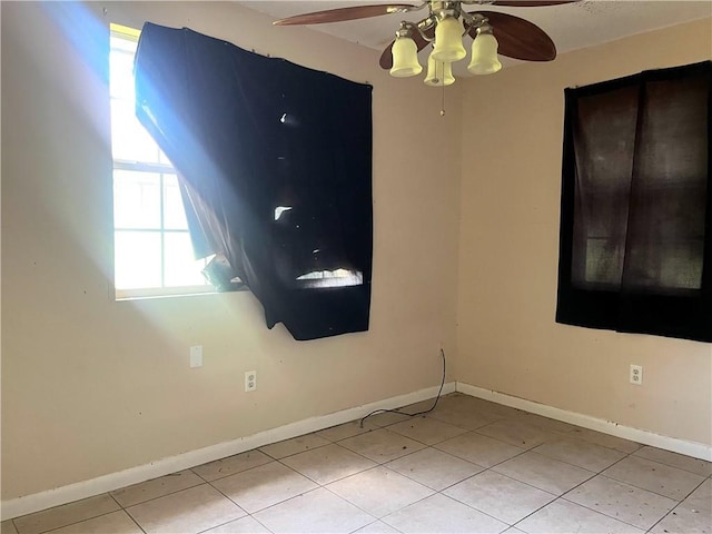 2221 Annette St, New Orleans, LA 70119 - spare room with baseboards, a ceiling fan, and light tile patterned flooring