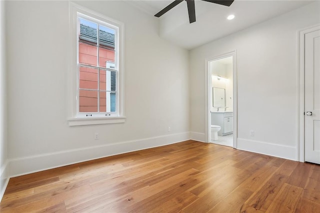 unfurnished bedroom featuring light wood-style floors, baseboards, recessed lighting, connected bathroom, and a ceiling fan