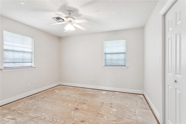 unfurnished bedroom featuring baseboards, a ceiling fan, a textured ceiling, and a closet