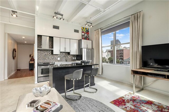 835 Julia St Unit 17, New Orleans, LA 70113 - kitchen featuring appliances with stainless steel finishes, tasteful backsplash, a kitchen island, and visible vents