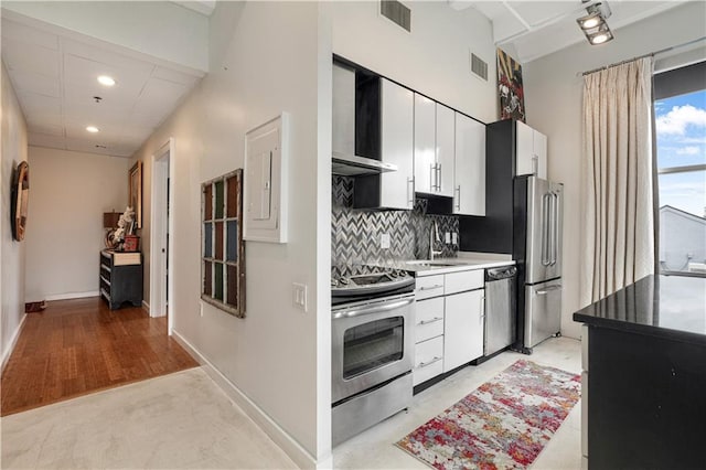 835 Julia St Unit 17, New Orleans, LA 70113 - kitchen with backsplash, visible vents, appliances with stainless steel finishes, and wall chimney exhaust hood
