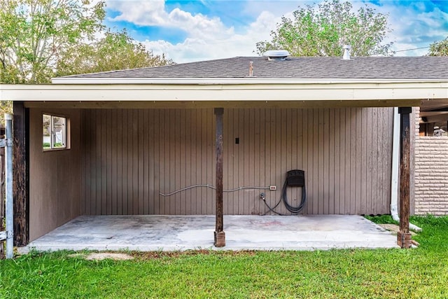 rear view of house featuring a shingled roof