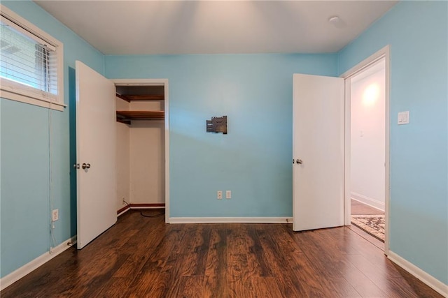 unfurnished bedroom featuring baseboards and wood finished floors