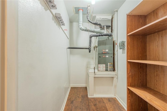 walk in closet with wood finished floors