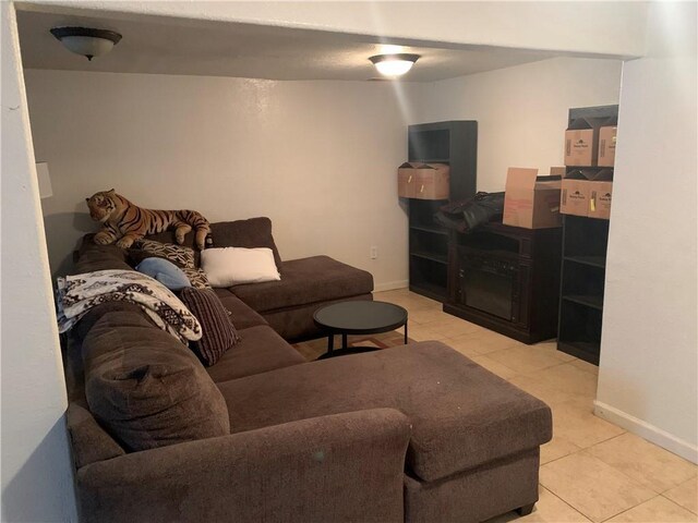 living room with light tile patterned floors and baseboards