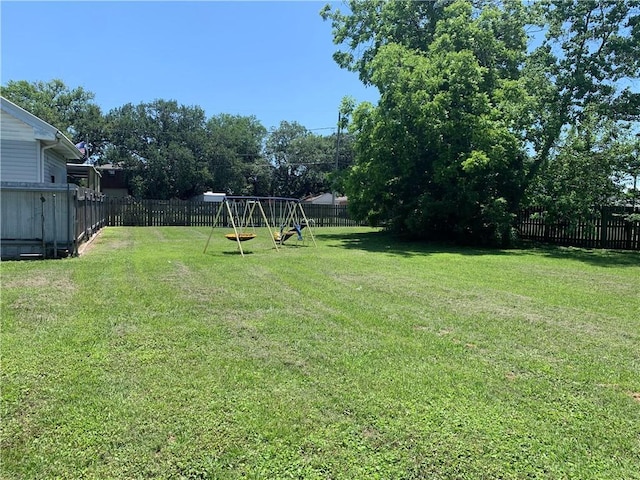 view of yard with a playground and a fenced backyard