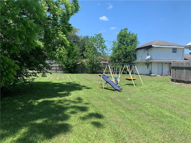 view of yard featuring a fenced backyard and a playground