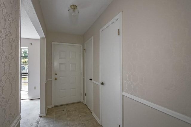 corridor featuring baseboards