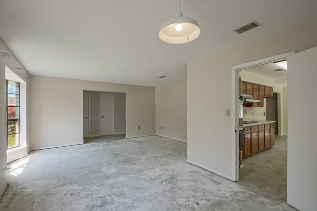 empty room featuring unfinished concrete floors and visible vents