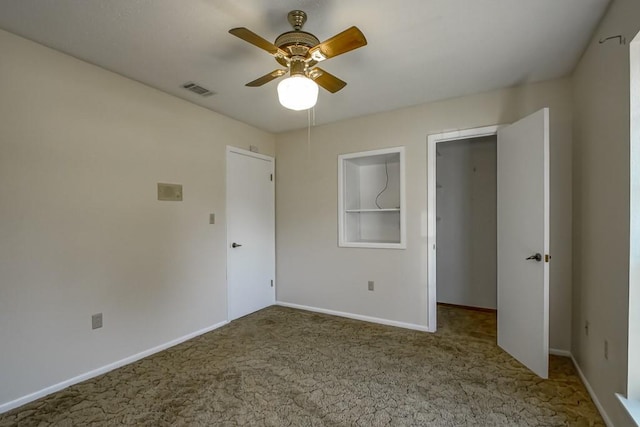 unfurnished bedroom featuring ceiling fan, visible vents, baseboards, and carpet