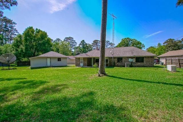 back of house with a lawn, fence, and cooling unit