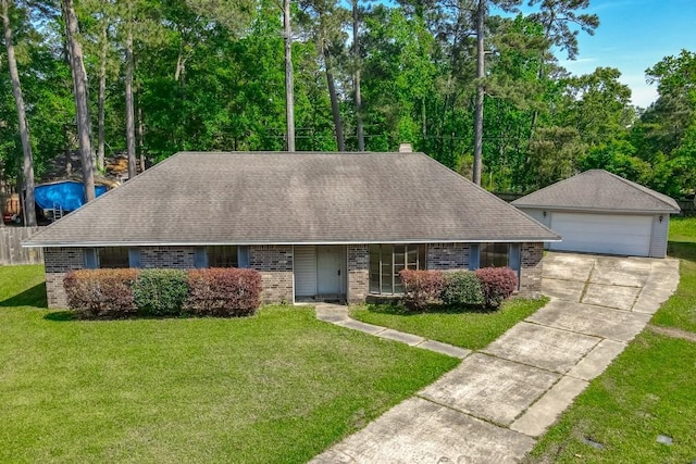 ranch-style home with a detached garage, a front lawn, and brick siding