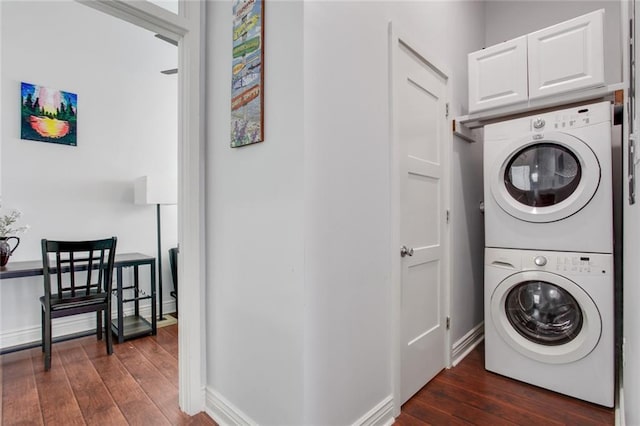 2430 Clara St, New Orleans, LA 70113 - laundry room with estacked washer and dryer, dark wood finished floors, and cabinet space