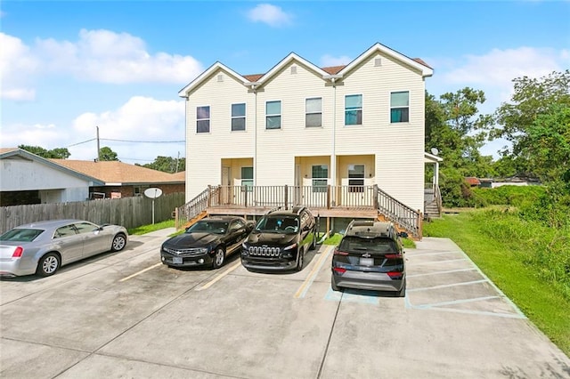 1209 Tallow Tree Ln, Harvey, LA 70058 - townhome / multi-family property featuring fence, uncovered parking, and stairway