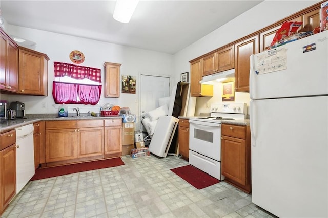 1209 Tallow Tree Ln, Harvey, LA 70058 - kitchen featuring brown cabinetry, a sink, light floors, under cabinet range hood, and white appliances