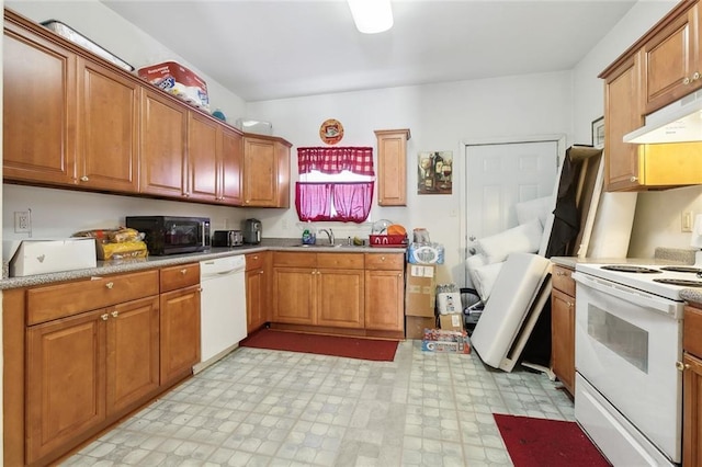 1209 Tallow Tree Ln, Harvey, LA 70058 - kitchen featuring white appliances, brown cabinets, under cabinet range hood, and a sink