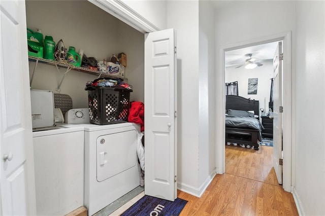 1209 Tallow Tree Ln, Harvey, LA 70058 - washroom featuring laundry area, a ceiling fan, light wood-type flooring, baseboards, and washer and clothes dryer