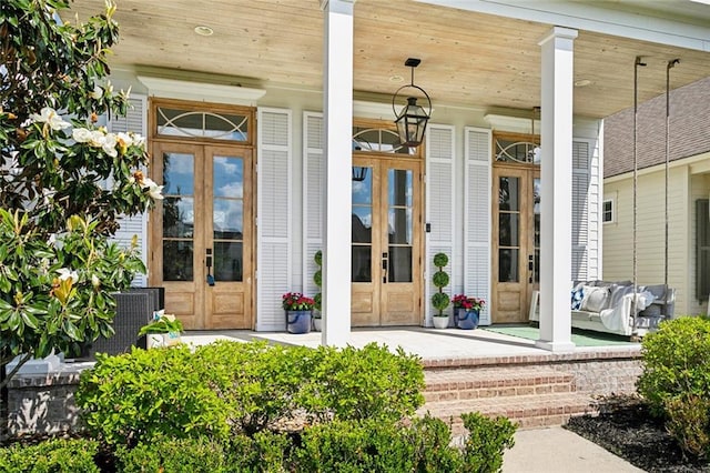 property entrance with a porch and french doors