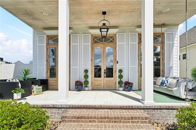 doorway to property with french doors and a porch