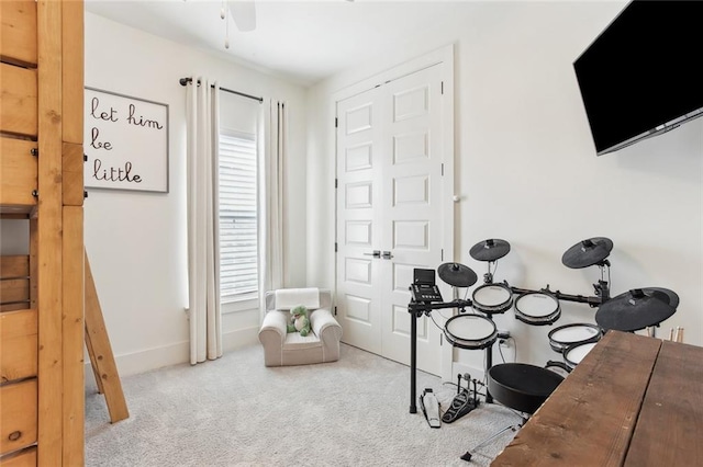interior space with carpet floors, baseboards, and ceiling fan