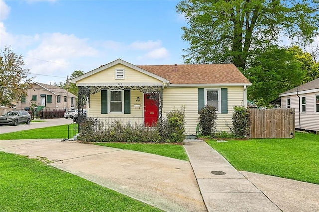 bungalow-style home featuring a porch and roof with shingles