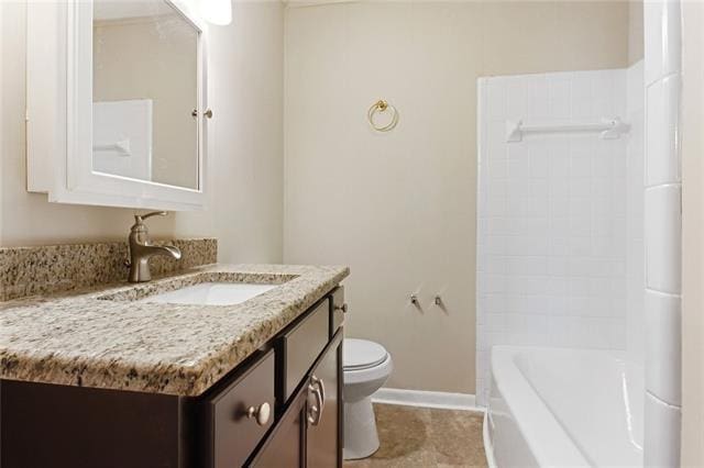 bathroom with vanity, toilet, and baseboards