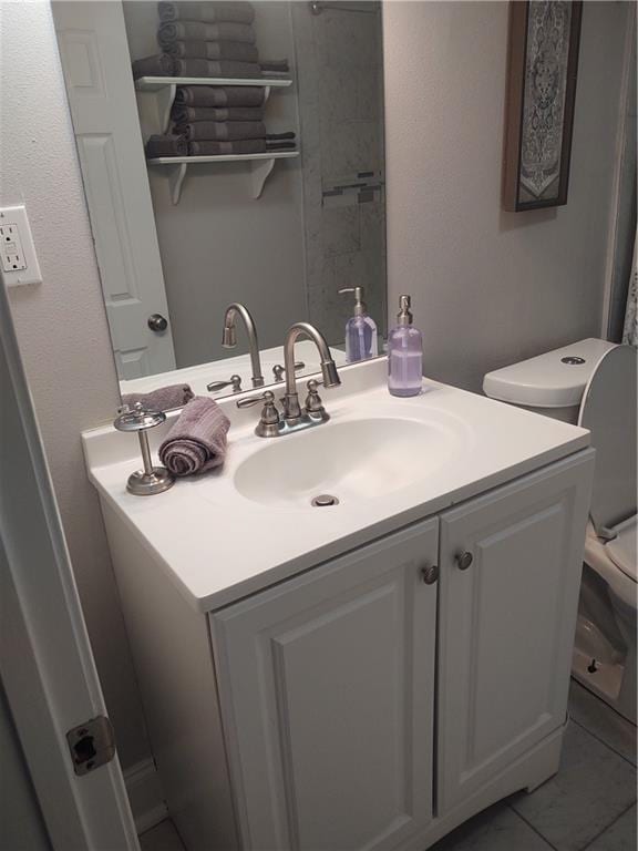 bathroom with vanity, tile patterned floors, and toilet