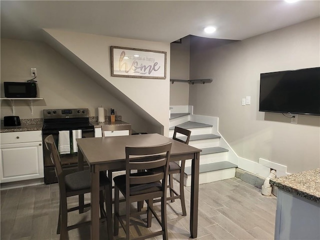592426 Saint Claude St, New Orleans, LA 70117 - dining space featuring light wood finished floors, stairs, and recessed lighting