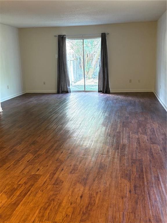 220002 Division St, Metairie, LA 70001 - spare room with baseboards and dark wood-style floors