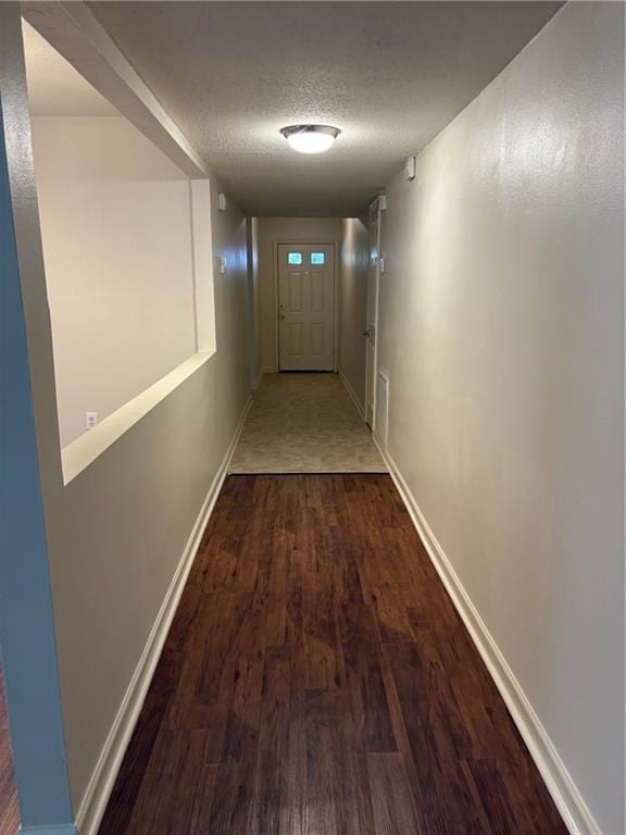 220002 Division St, Metairie, LA 70001 - corridor featuring baseboards, a textured ceiling, and wood finished floors