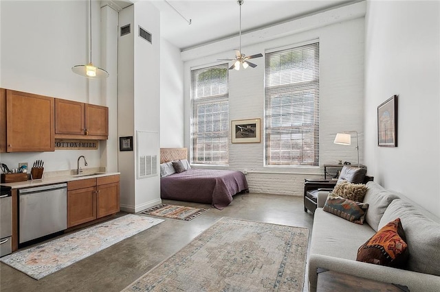 bedroom with a sink, a high ceiling, finished concrete flooring, and visible vents