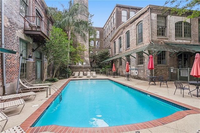 pool featuring a patio and fence