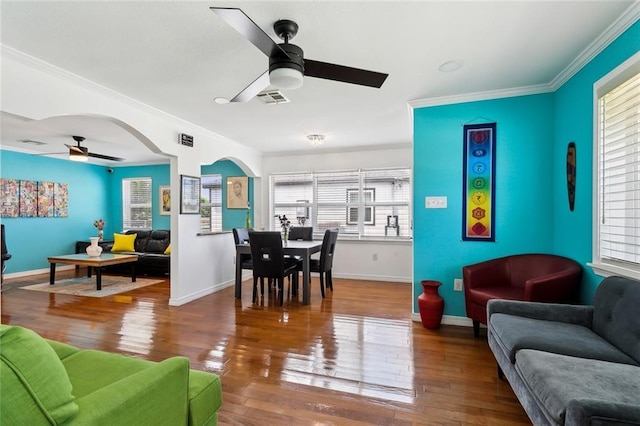 living room with crown molding, ceiling fan, hardwood / wood-style floors, and visible vents