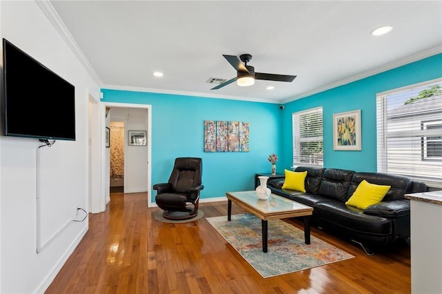 living room featuring recessed lighting, visible vents, ornamental molding, and wood finished floors