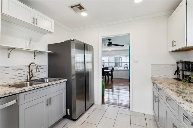 kitchen with backsplash, visible vents, open shelves, a sink, and stainless steel appliances