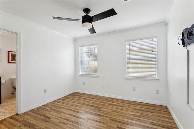 unfurnished bedroom with baseboards, ceiling fan, ornamental molding, and wood finished floors