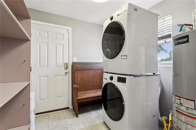 laundry room with laundry area, stacked washing maching and dryer, and water heater