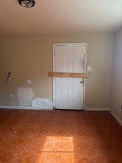 spare room featuring baseboards