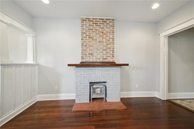 unfurnished living room featuring baseboards, recessed lighting, and wood finished floors