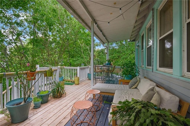 wooden terrace with outdoor dining area