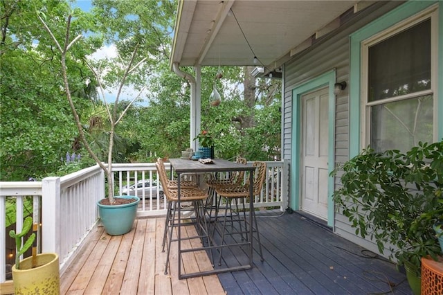 wooden terrace featuring outdoor dining area