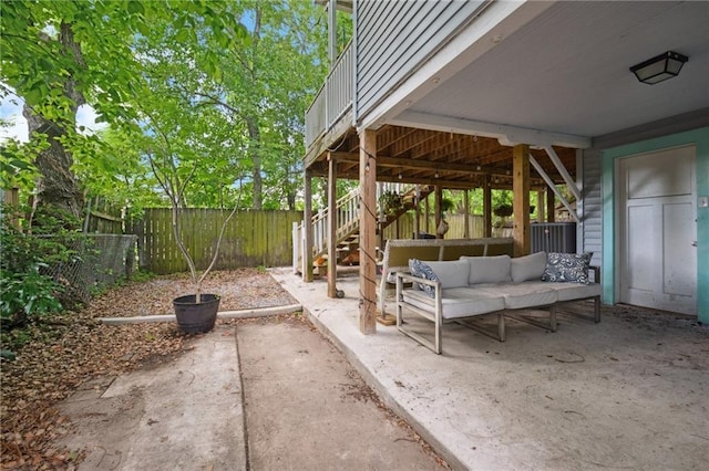 view of patio featuring a fenced backyard, outdoor lounge area, and stairway
