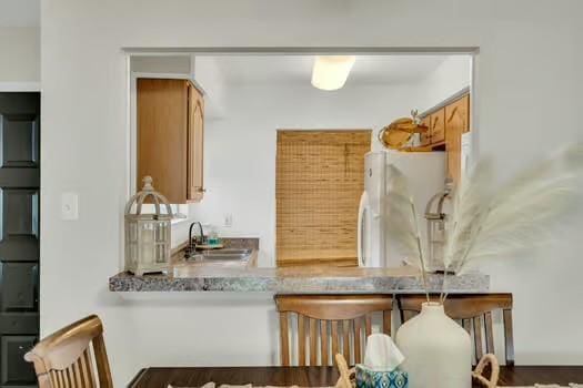 3320 Timberlane Way Dr Unit 134, Harvey, LA 70058 - kitchen with freestanding refrigerator, a sink, and brown cabinets